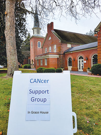 A sandwich board sign outside Grace Episcopal Church touts the special support sessions for cancer patients